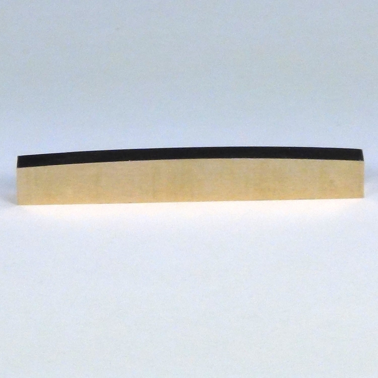 Brass guitar nut curved top
